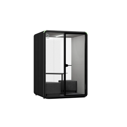 A modern black privacy pod phone booth with glass panels, a built-in desk, and a gray upholstered bench inside, shown on a plain white background.