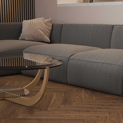 Gray sofa with a wooden coffee table on a wooden floor