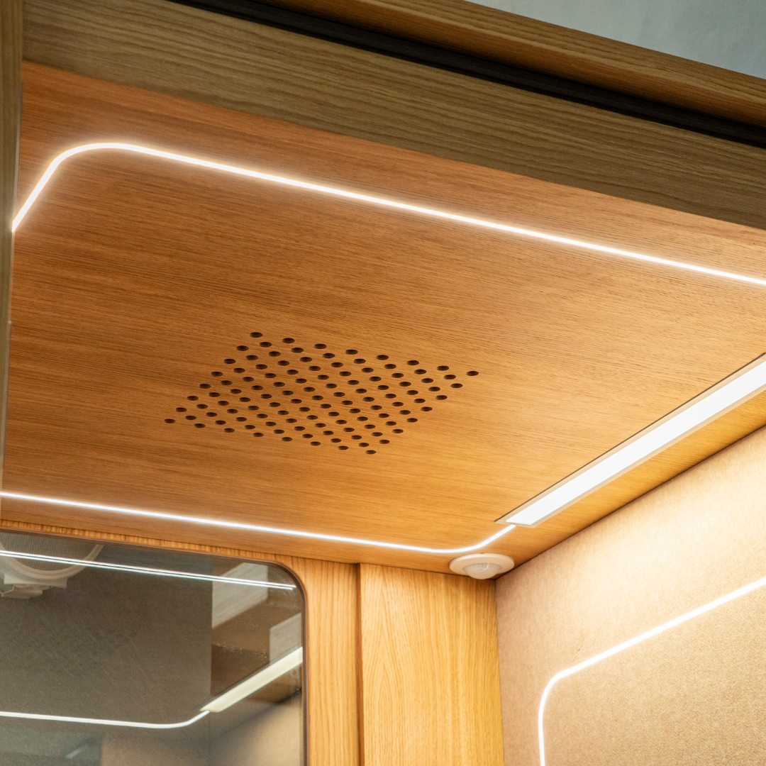 Wooden panel on the pod's inside, with a ventilation grill and LED strip lighting